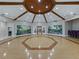 Expansive meeting room with hardwood floors, custom wood ceiling and muraled walls, creating a refined space at 3427 Waterlute Way, Lakeland, FL 33811