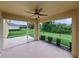 Covered screened patio with ceiling fan overlooking landscaped backyard with lush lawn at 3427 Waterlute Way, Lakeland, FL 33811