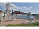 Community pool surrounded by lounge chairs and tables at 3427 Waterlute Way, Lakeland, FL 33811