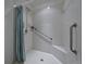 Accessible shower featuring white tile, a shower curtain, and grab bars at 3427 Waterlute Way, Lakeland, FL 33811