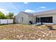 Spacious backyard showcasing the home's exterior, patio, and well-maintained fence at 367 Cloverdale Rd, Winter Haven, FL 33884