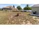 Large backyard featuring lawn and home exterior, with a grill and surrounding fence at 367 Cloverdale Rd, Winter Haven, FL 33884