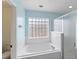 Bright bathroom with glass block window, soaking tub, and separate shower at 367 Cloverdale Rd, Winter Haven, FL 33884