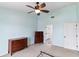 Bedroom featuring light blue walls, ceiling fan, dresser and neutral carpet at 367 Cloverdale Rd, Winter Haven, FL 33884