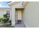 Inviting front porch with neutral paint, decorative window, and charming welcome mat at 367 Cloverdale Rd, Winter Haven, FL 33884