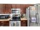 Well-lit kitchen featuring stainless steel appliances, granite countertops, and dark wood cabinetry at 367 Cloverdale Rd, Winter Haven, FL 33884