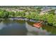 Expansive lakefront community features docks, lush trees, and tranquil waters from an aerial view at 3806 Osprey Pointe Cir, Winter Haven, FL 33884