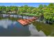 Scenic view of a wooden dock on a calm lake, enhanced by surrounding trees and natural beauty at 3806 Osprey Pointe Cir, Winter Haven, FL 33884