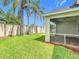 Lush backyard featuring a screened-in lanai, green lawn, and privacy wall at 3806 Osprey Pointe Cir, Winter Haven, FL 33884