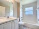 A full bathroom features a combined tub and shower with white tile and updated vanity at 3806 Osprey Pointe Cir, Winter Haven, FL 33884