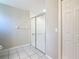 Bathroom showcasing a glass door shower, neutral paint, and a white tiled floor at 3806 Osprey Pointe Cir, Winter Haven, FL 33884