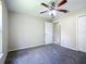 A carpeted bedroom featuring a ceiling fan and neutral paint provides a calm living space at 3806 Osprey Pointe Cir, Winter Haven, FL 33884