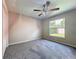 Comfortable bedroom with neutral walls, carpet, ceiling fan and a window at 3806 Osprey Pointe Cir, Winter Haven, FL 33884