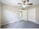 A carpeted bedroom featuring a ceiling fan and neutral paint provides a calm living space at 3806 Osprey Pointe Cir, Winter Haven, FL 33884