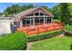 Community clubhouse boasts large windows, an outdoor deck with tables, and a well-maintained lawn at 3806 Osprey Pointe Cir, Winter Haven, FL 33884