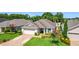 Landscaped single-story home featuring a brick driveway and mature trees at 3806 Osprey Pointe Cir, Winter Haven, FL 33884