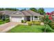 Charming single-story home featuring manicured landscaping and a brick driveway at 3806 Osprey Pointe Cir, Winter Haven, FL 33884