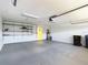 Spacious garage with gray epoxy flooring, built-in shelves, water heater and ample storage space at 3806 Osprey Pointe Cir, Winter Haven, FL 33884