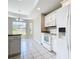 Bright kitchen with white appliances, tiled floor, and a window with a view at 3806 Osprey Pointe Cir, Winter Haven, FL 33884