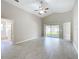 Spacious living room with high ceilings and sliding glass doors to the backyard at 3806 Osprey Pointe Cir, Winter Haven, FL 33884