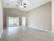 Bright living room featuring vaulted ceilings, a ceiling fan, and backyard access at 3806 Osprey Pointe Cir, Winter Haven, FL 33884