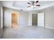 Spacious primary bedroom showcasing wood-look floors, ceiling fan, and ensuite bathroom at 3806 Osprey Pointe Cir, Winter Haven, FL 33884