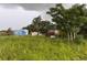 Image features a dilapidated and overgrown site with multiple sheds and an unfinished building at 4011 E Robinson Dr, Haines City, FL 33844