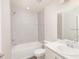 Bright bathroom featuring a tub/shower combo, tile surround, and a single vanity with neutral countertops at 408 Ituna Cir, Winter Haven, FL 33881