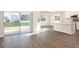 Open-concept living room featuring sliding glass doors to the backyard and views of the kitchen area at 408 Ituna Cir, Winter Haven, FL 33881