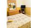 Bedroom featuring neutral color scheme with bed, dresser, mirror, and a small television at 4102 Lake Marion Golf Resort # 4102, Kissimmee, FL 34759