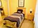 Comfortable bedroom featuring a twin bed, carpet flooring, and natural light at 4102 Lake Marion Golf Resort # 4102, Kissimmee, FL 34759