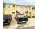 Condominium exterior with a parking lot, two vehicles, and exterior stairs at 4102 Lake Marion Golf Resort # 4102, Kissimmee, FL 34759