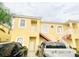 Inviting yellow condo featuring convenient stair access and well-maintained landscaping at 4102 Lake Marion Golf Resort # 4102, Kissimmee, FL 34759