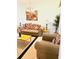 Well-lit living room showcasing comfortable seating, decor, and a view into additional living spaces at 4102 Lake Marion Golf Resort # 4102, Kissimmee, FL 34759