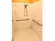 Clean shower stall featuring a showerhead and safety grab bars at 4102 Lake Marion Golf Resort # 4102, Kissimmee, FL 34759