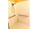Clean shower stall featuring a handheld shower head and safety grab bars at 4102 Lake Marion Golf Resort # 4102, Kissimmee, FL 34759