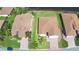 Aerial view showcases the property's layout, landscaping, and proximity to neighboring homes at 4188 Muirfield Loop, Lake Wales, FL 33859