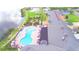 Aerial view of the resort-style pool and meticulously landscaped gardens near the Clubhouse at 4188 Muirfield Loop, Lake Wales, FL 33859