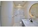 Bathroom featuring a walk-in tub and granite vanity with a round mirror at 4188 Muirfield Loop, Lake Wales, FL 33859