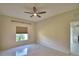 Bedroom with tile floors, ceiling fan and a view from the window at 4188 Muirfield Loop, Lake Wales, FL 33859