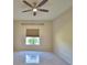 Neutral bedroom featuring tile floors, ceiling fan and a window view at 4188 Muirfield Loop, Lake Wales, FL 33859