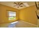 This home includes a bedroom with tile floor, ceiling fan and great natural light at 4188 Muirfield Loop, Lake Wales, FL 33859