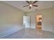 Bedroom with neutral walls, tile floors, ceiling fan and ensuite bathroom at 4188 Muirfield Loop, Lake Wales, FL 33859