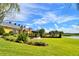 Expansive lawn with manicured landscaping and views of the clubhouse and a water feature at 4188 Muirfield Loop, Lake Wales, FL 33859