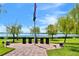 A lakeside community monument with an American flag waving on a beautiful, sunny day at 4188 Muirfield Loop, Lake Wales, FL 33859
