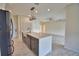 Open kitchen area featuring an island and stainless steel refrigerator at 4188 Muirfield Loop, Lake Wales, FL 33859