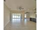 Spacious living area with large window overlooking the water, a ceiling fan, and tile flooring at 4188 Muirfield Loop, Lake Wales, FL 33859