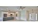 Open-concept living space with a modern kitchen featuring stainless steel appliances and a sleek island at 4188 Muirfield Loop, Lake Wales, FL 33859