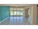 Open living space with tile flooring and large window view of lake at 4188 Muirfield Loop, Lake Wales, FL 33859