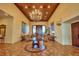 Grand lobby featuring a high, coffered ceiling, tile flooring, and elegant furniture at 4188 Muirfield Loop, Lake Wales, FL 33859